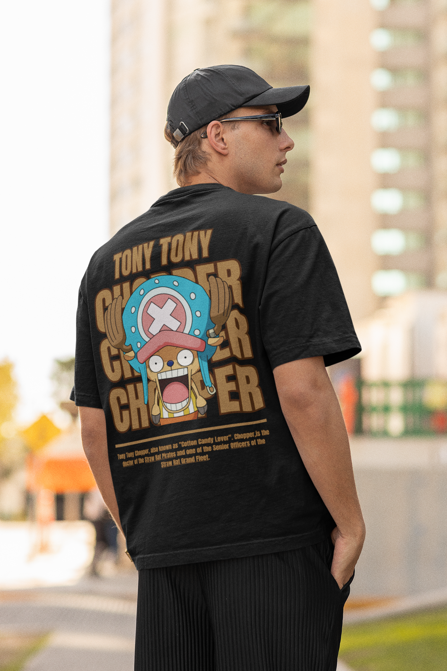 Back view a male model wearing a black oversized t-shirt featuring Tony Chopper from the One Piece anime.