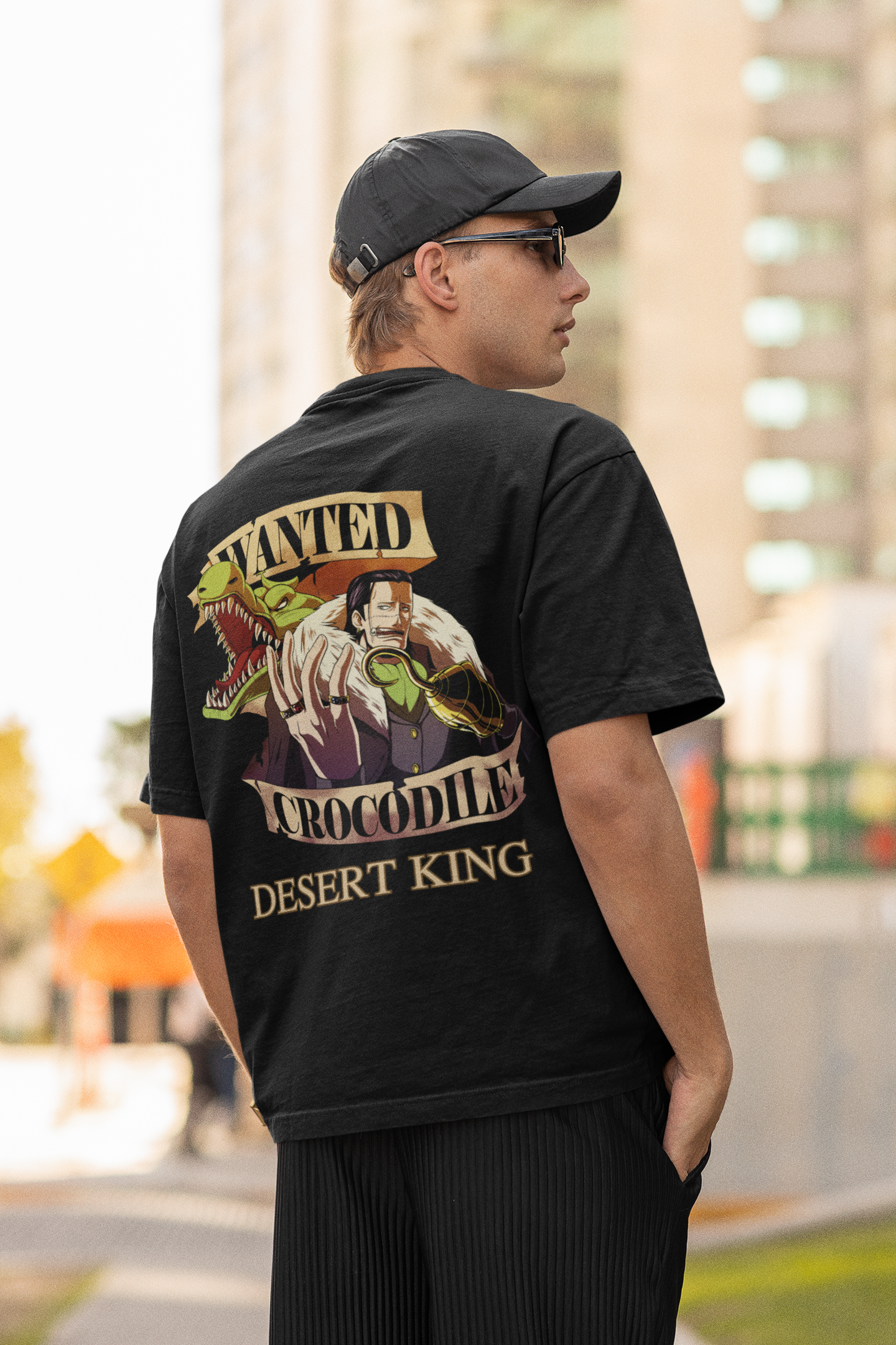 Back view of a male model wearing a black oversized t-shirt featuring Crocodile, the Desiccation Master, from the One Piece anime.