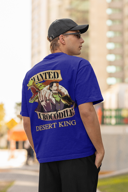 Back view of a male model wearing a royal blue oversized t-shirt featuring Crocodile, the Desiccation Master, from the One Piece anime.