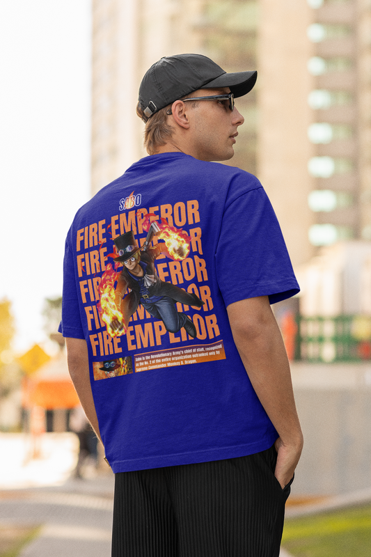 Back view of a male model wearing a royal blue oversized t-shirt featuring Sabo with the text "Flame Emperor."