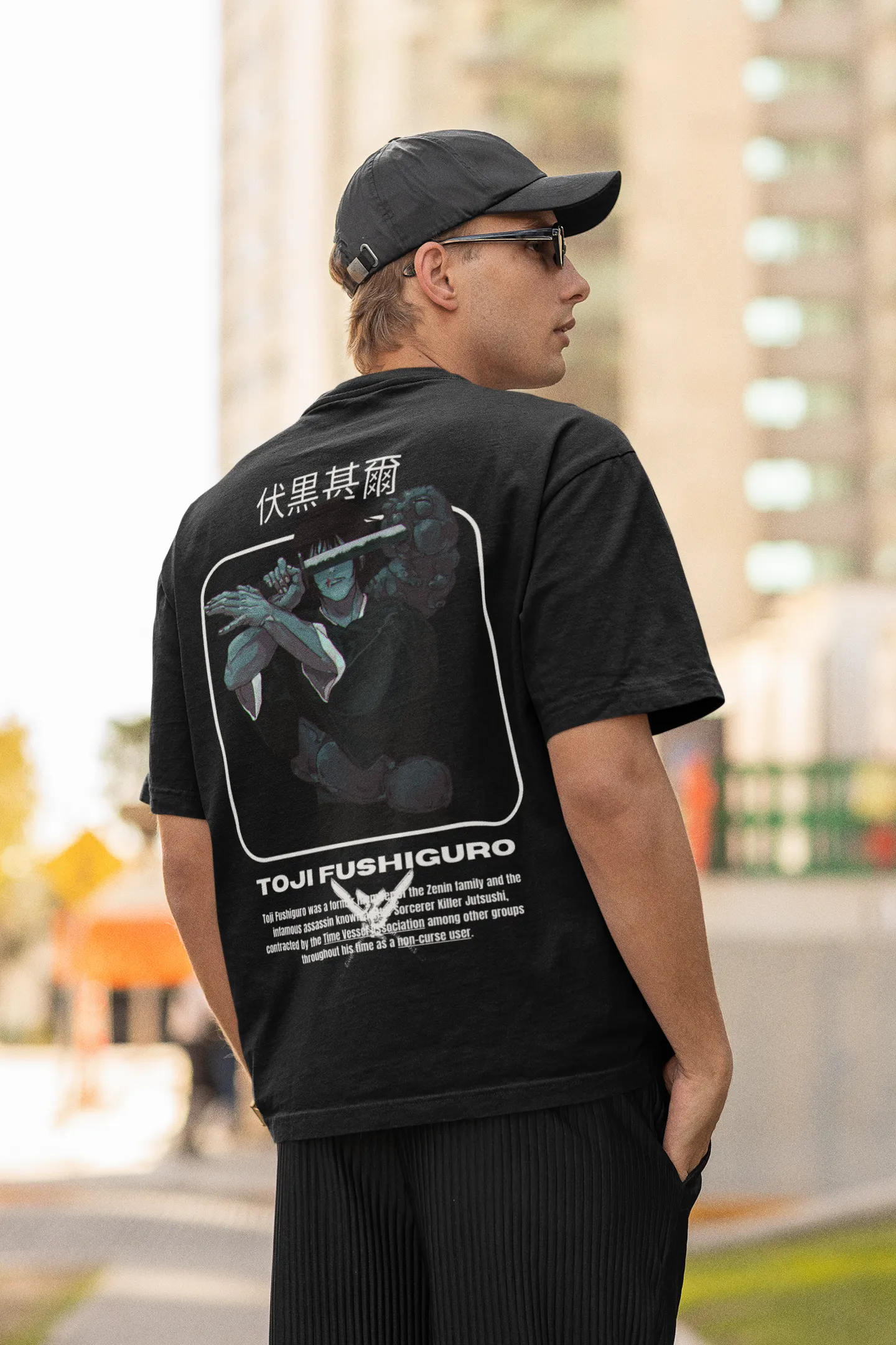 Back view of a male model wearing a black oversized t-shirt featuring Toji Fushiguro from the Jujutsu Kaisen anime.