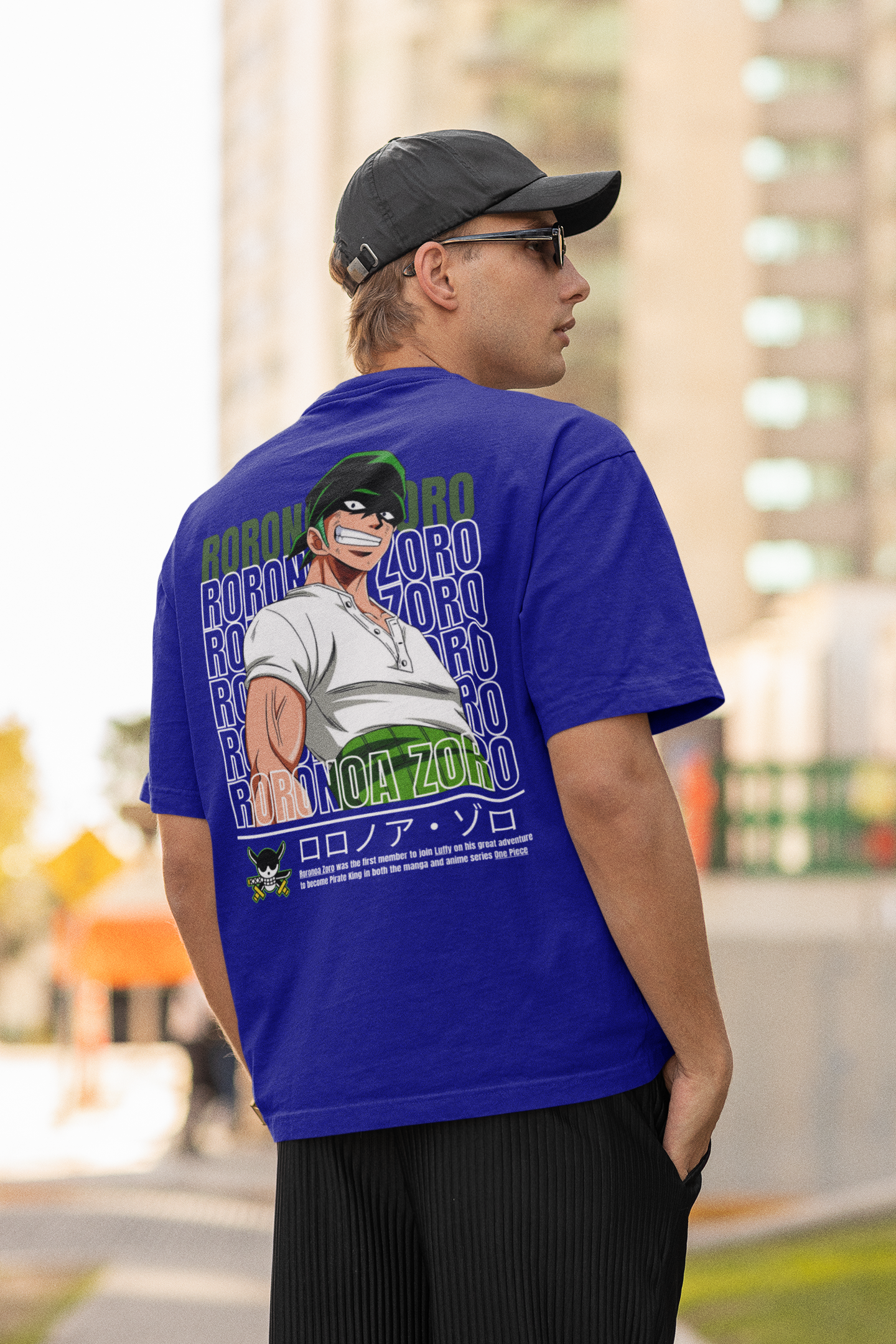 Back view of a male model wearing a royal blue oversized t-shirt featuring Roronoa Zoro from the One Piece anime.