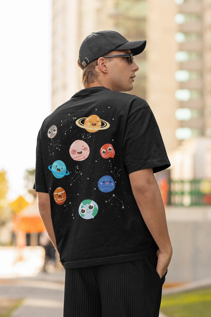 Back view of male model wearing an black oversized t-shirt featuring a colorful "Solar System" design with all eight planets.