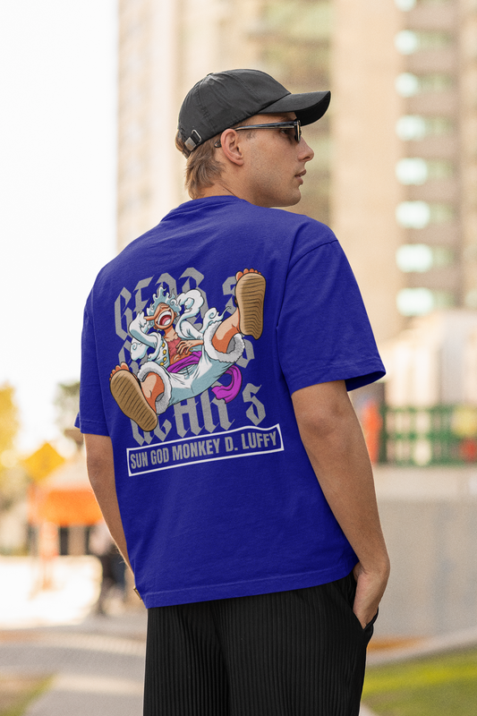 Back view of a male model wearing a royal blue oversized t-shirt featuring Luffy in his Gear 5 form from the One Piece anime.