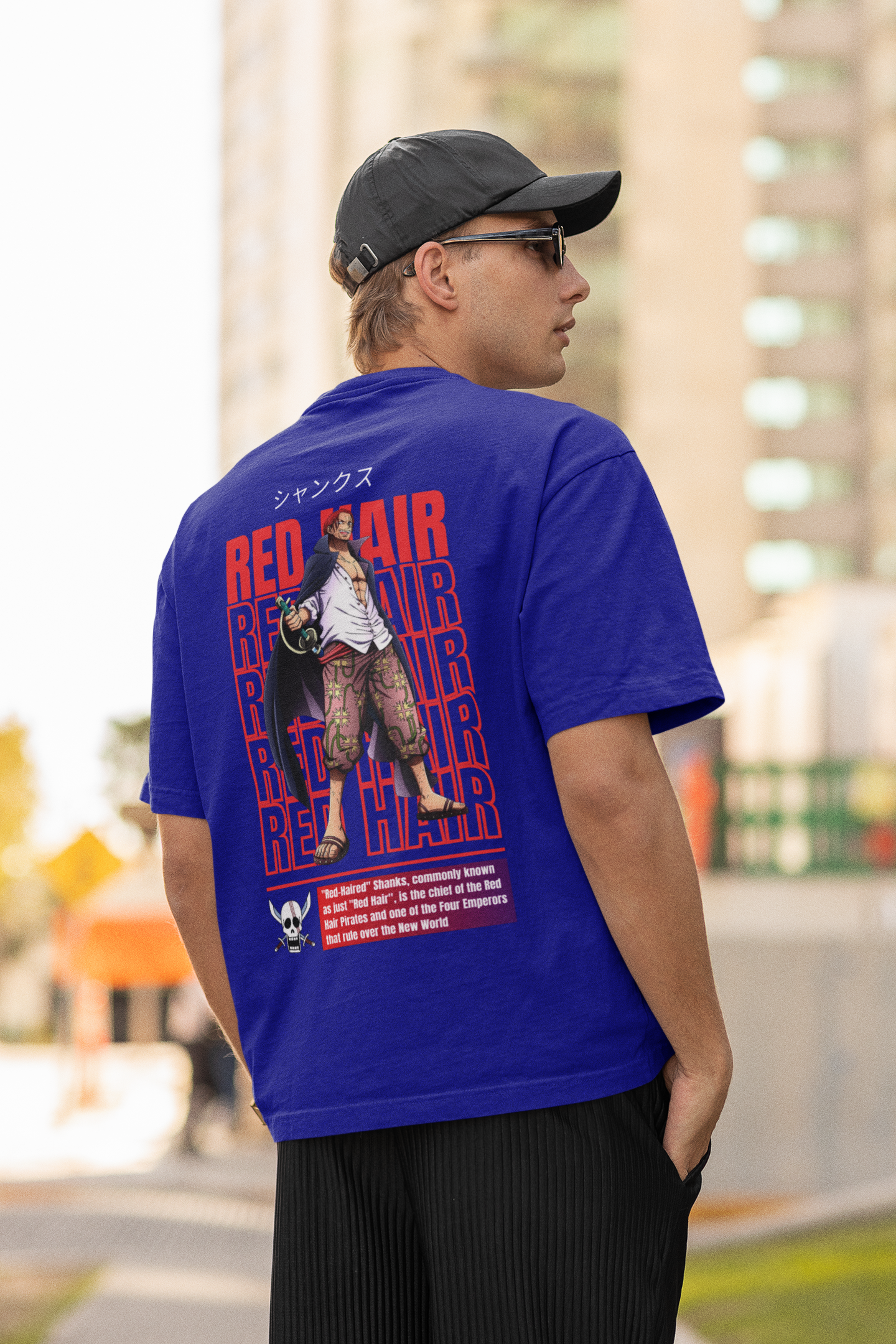 Back view of a male model wearing a royal blue oversized t-shirt featuring Red-Haired Shanks from the One Piece anime.