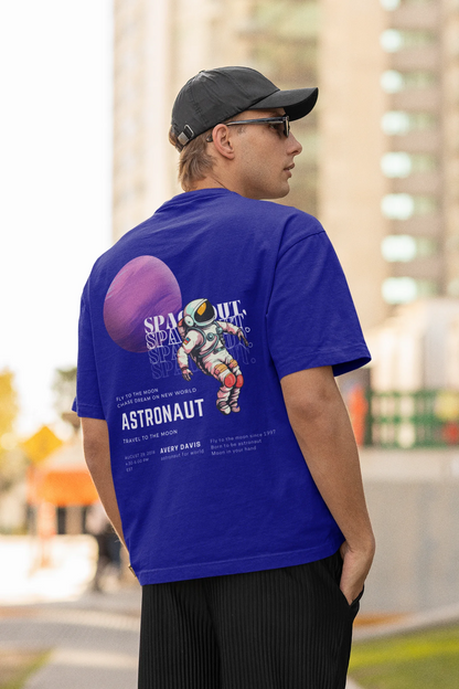 Back view of male model wearing a blue oversized t-shirt featuring a design inspired by the cosmos and galaxies "Fly Me to the Moon" and subtle hints of space exploration.