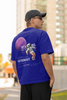 Back view of male model wearing a blue oversized t-shirt featuring a design inspired by the cosmos and galaxies 