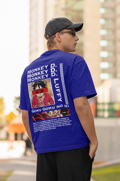 Back view of a male model wearing a royal blue oversized t-shirt featuring Monkey D. Luffy from the One Piece anime.