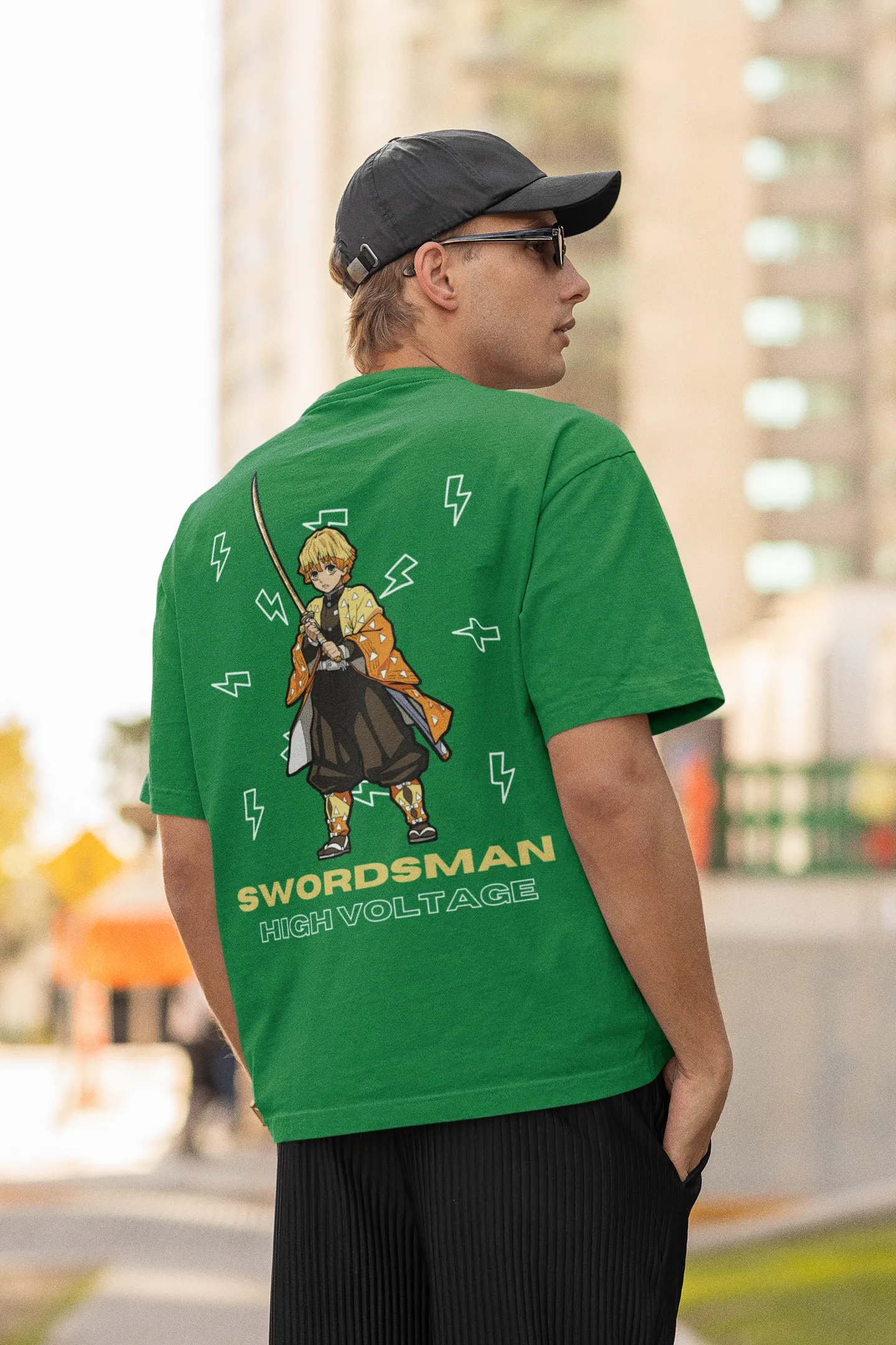 Back view of a male model wearing a forest green oversized t-shirt featuring Zenitsu Agatsuma with the text "High Voltage".