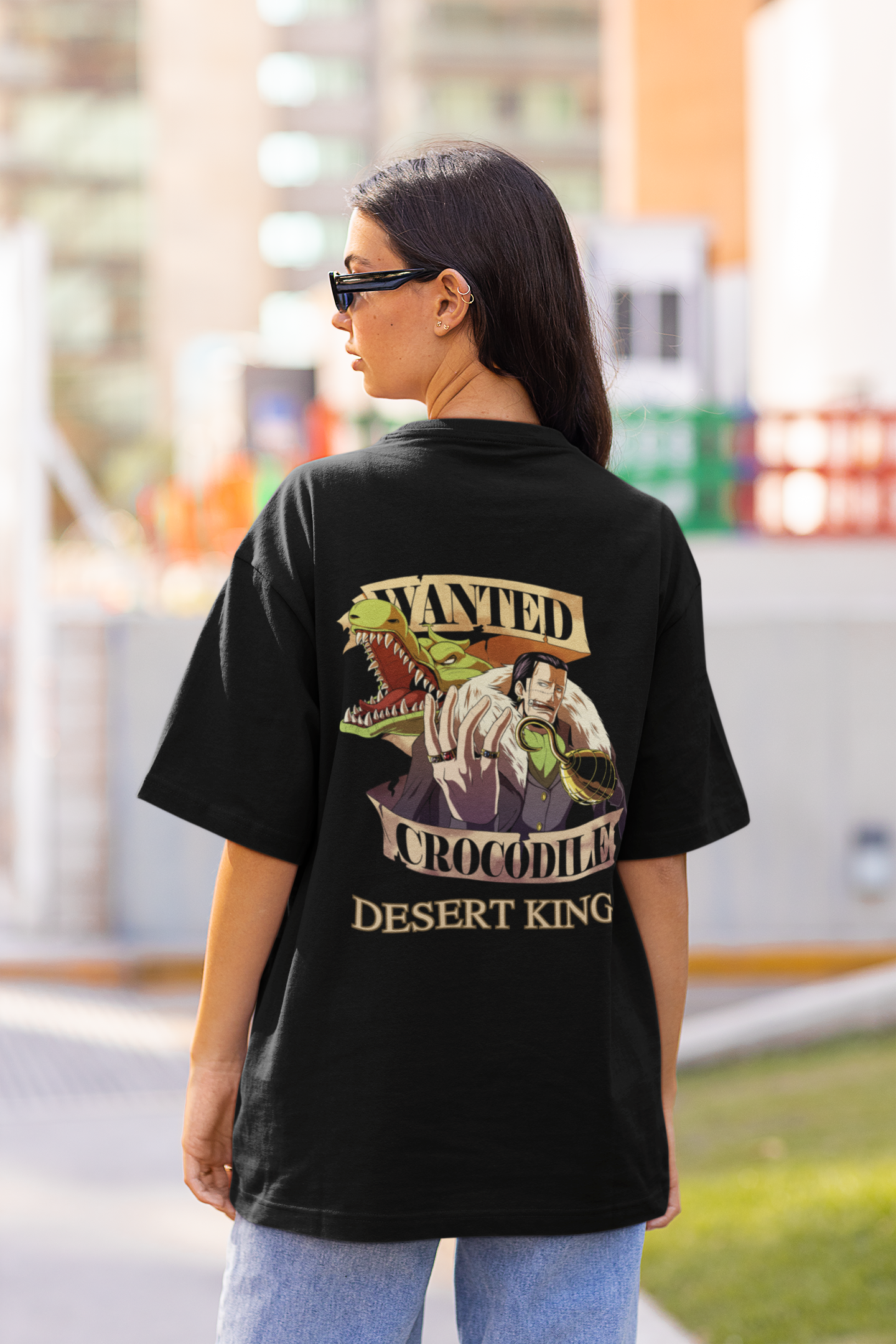 Back view of a female model wearing a black oversized t-shirt featuring Crocodile, the Desiccation Master, from the One Piece anime.