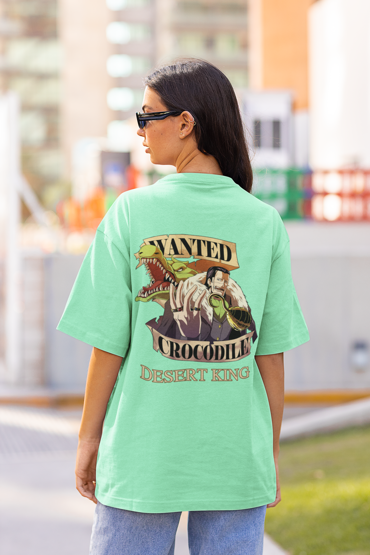 Back view of a female model wearing a mint green oversized t-shirt featuring Crocodile, the Desiccation Master, from the One Piece anime.