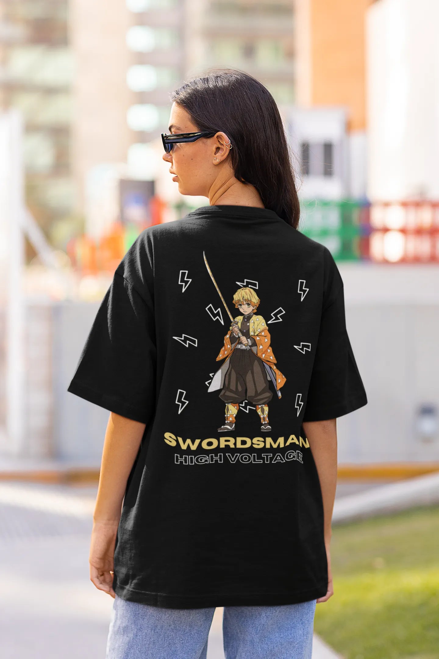 Back view of a female model wearing a black oversized t-shirt featuring Zenitsu Agatsuma with the text "High Voltage".