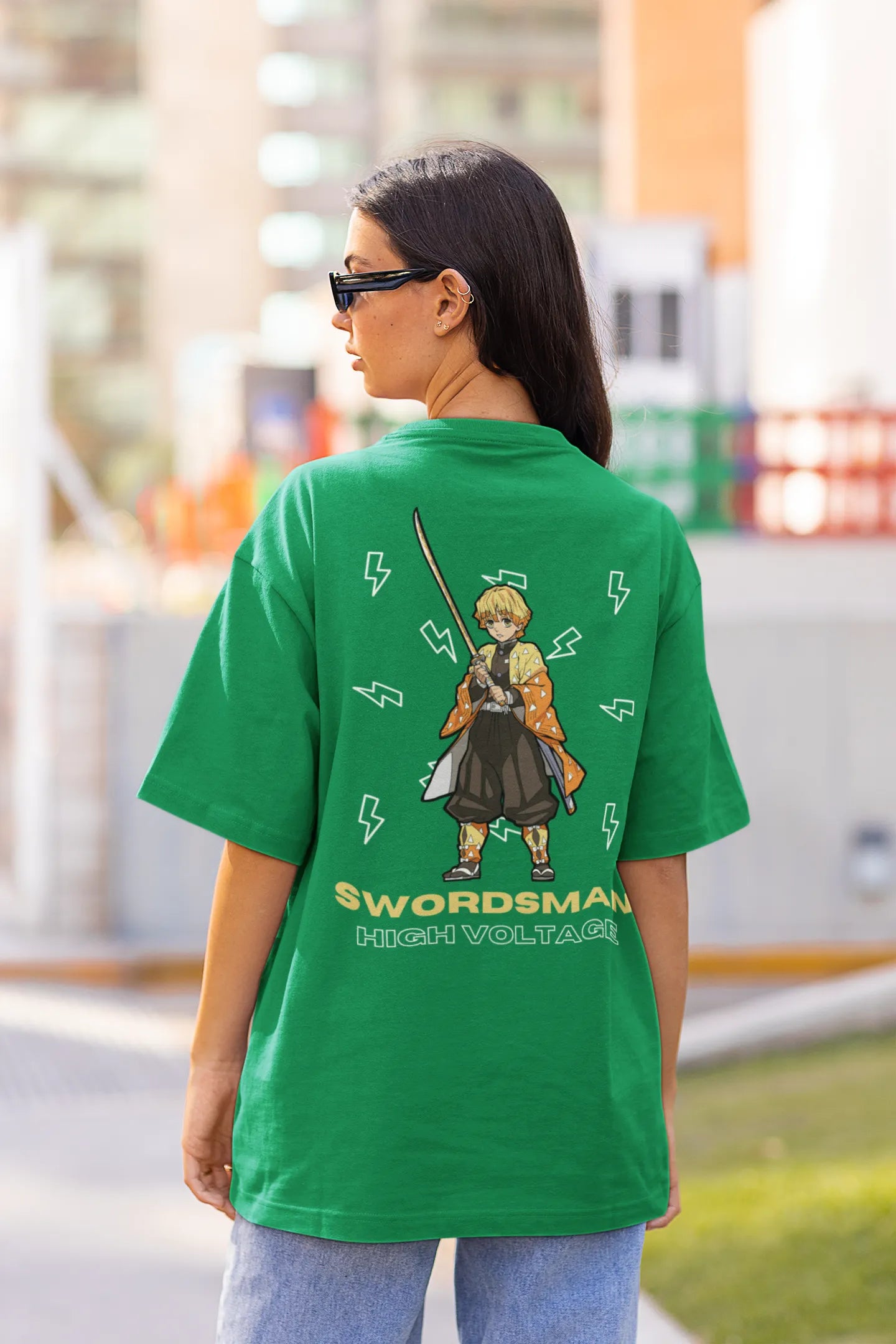 Back view of a female model wearing a forest green oversized t-shirt featuring Zenitsu Agatsuma with the text "High Voltage".