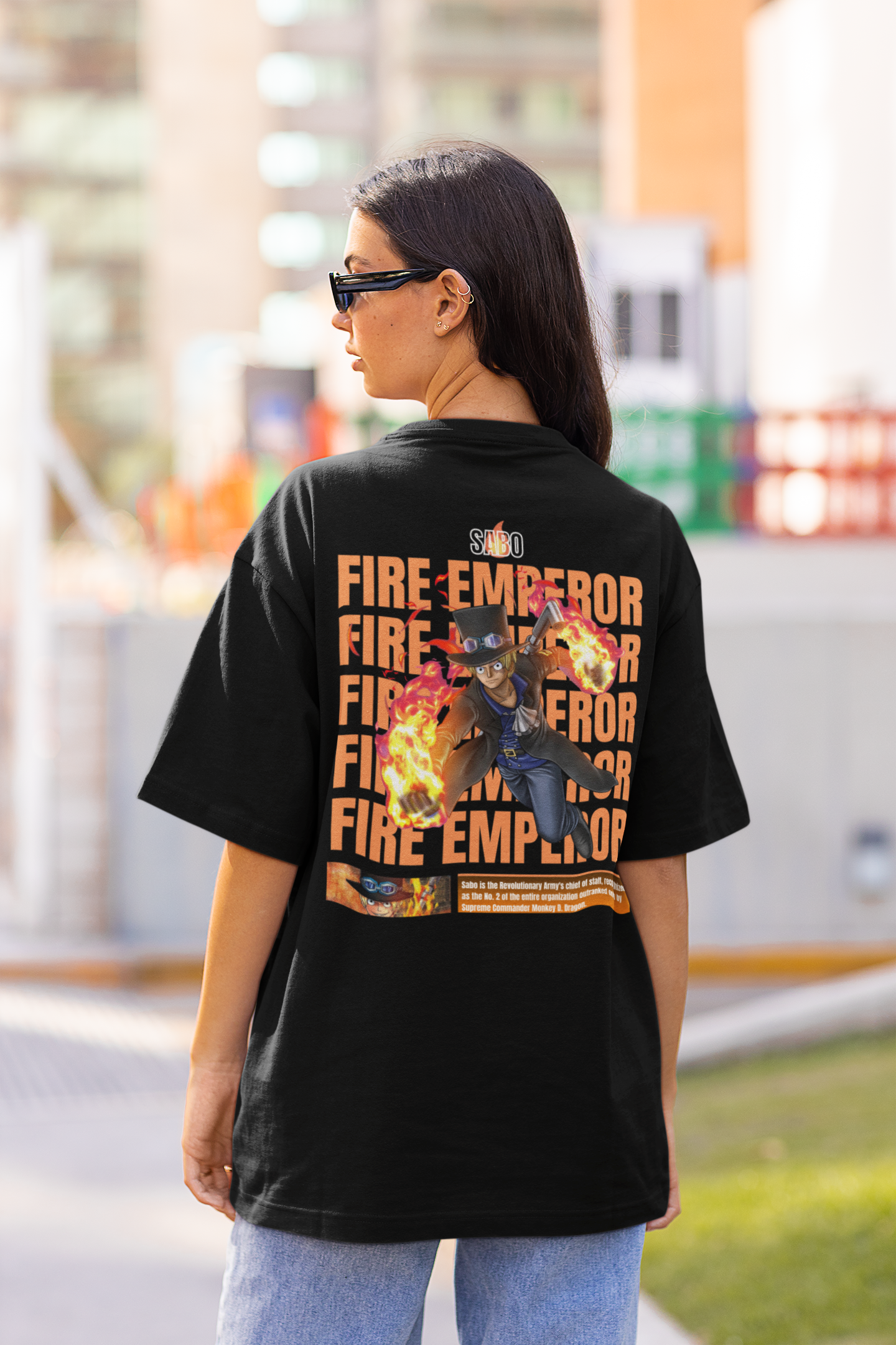 Back view of a female model wearing a black oversized t-shirt featuring Sabo with the text "Flame Emperor."