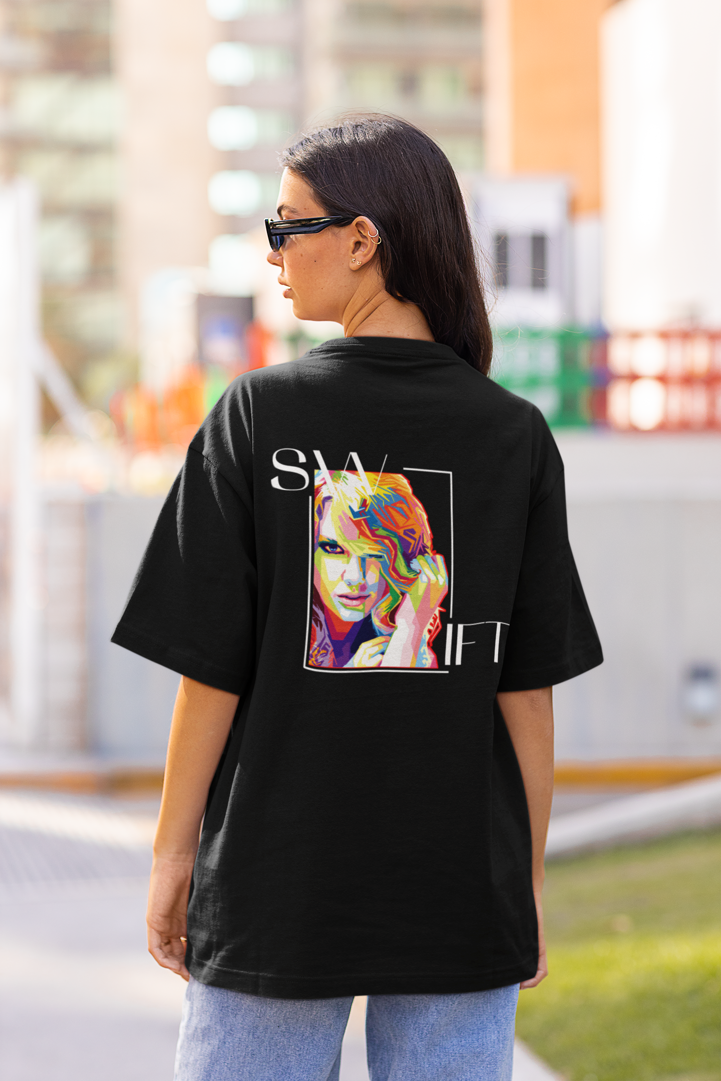 Back view of woman wearing black Oversize T-shirt featuring Swiftie design, taylor's version