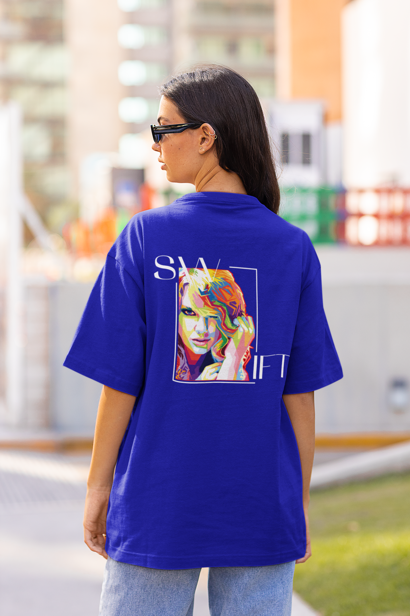 Back view of woman wearing blue Oversize T-shirt featuring Swiftie design, taylor's version