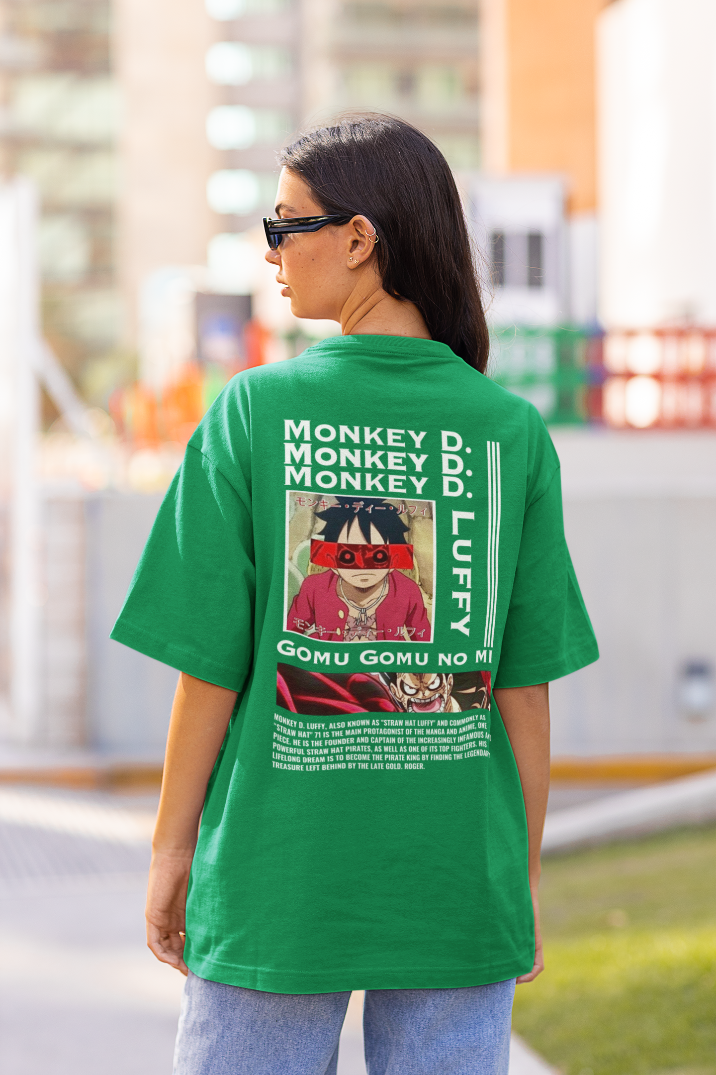 Back view of a female model wearing a forest green oversized t-shirt featuring Monkey D. Luffy from the One Piece anime.