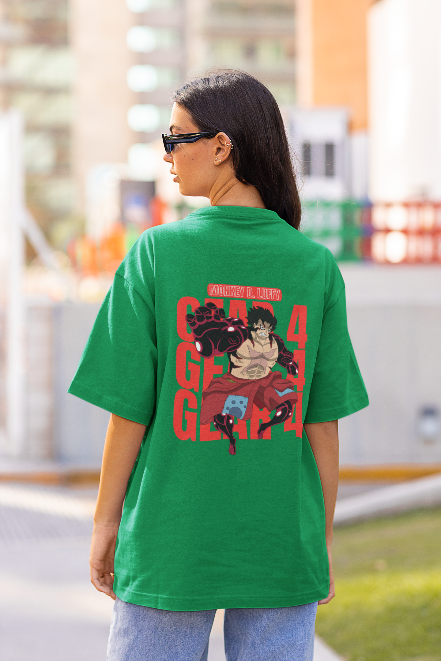 Back view of a female model wearing a forest green oversized t-shirt featuring Luffy in his Gear 4 Bounceman form from the One Piece anime.