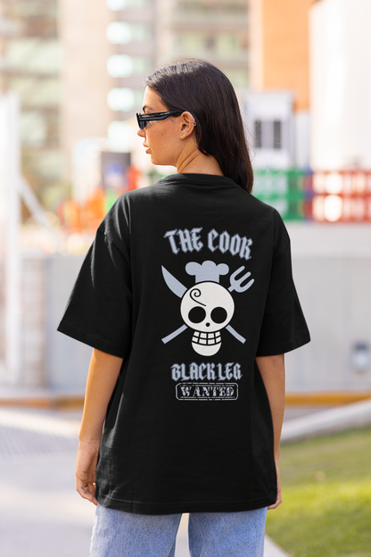 Back view of a female model wearing a black oversized t-shirt featuring Sanji's skull and crossbones logo and the text "The Cook and Black Leg."