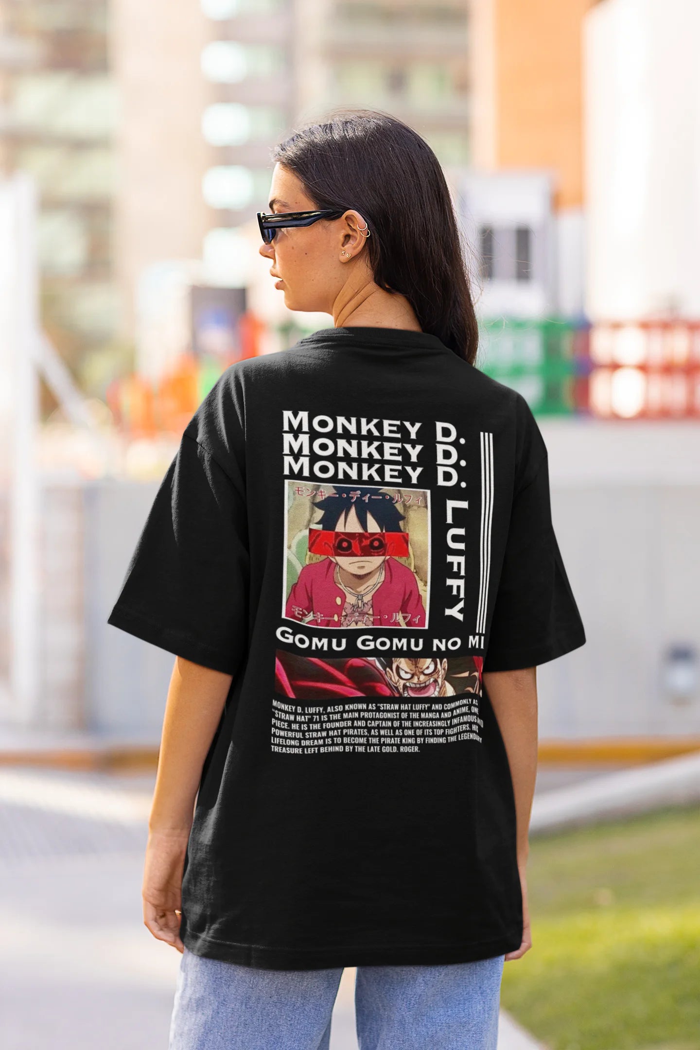 Back view of a female model wearing a black oversized t-shirt featuring Monkey D. Luffy from the One Piece anime.