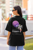 Back view of a female model wearing a black oversized t-shirt featuring a design inspired by the cosmos and galaxies 