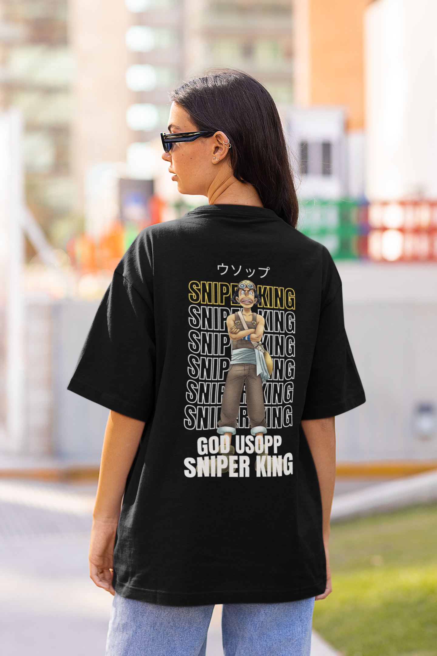 Back view of a female model wearing a black oversized t-shirt featuring Usopp from the One Piece anime.