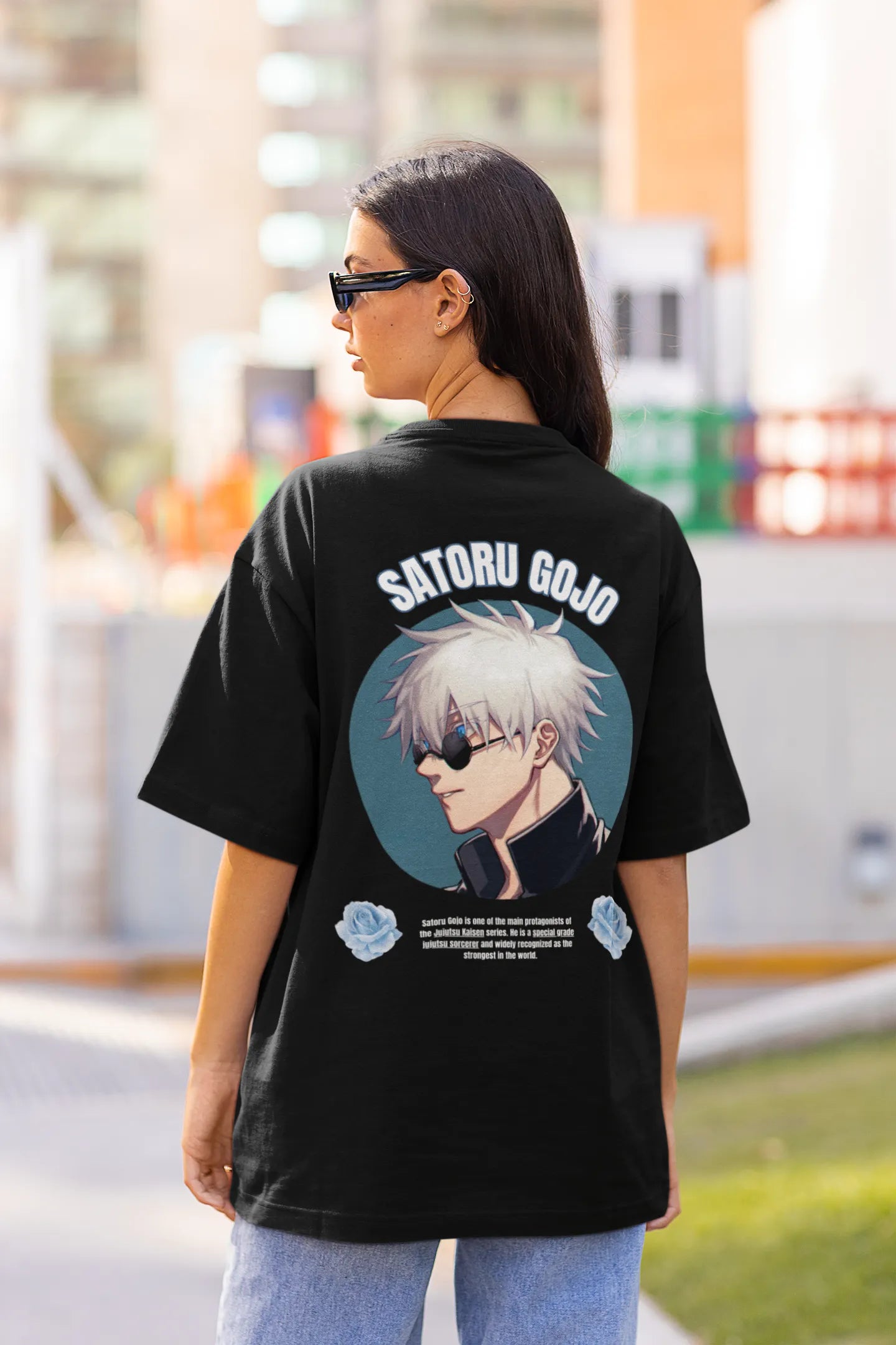 Back view of a female model wearing a black oversized t-shirt featuring Gojo Satoru from Jujutsu Kaisen with the text "Satoru Gojo."