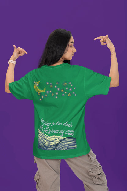 Back view of a female model wearing a forest green oversized t-shirt featuring lyrics from Ed Sheeran's song "Perfect" against a night sky design.