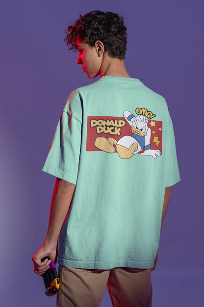 Back view of male model wearing mint green oversized Disney collection t-shirt featuring a classic Donald Duck design.