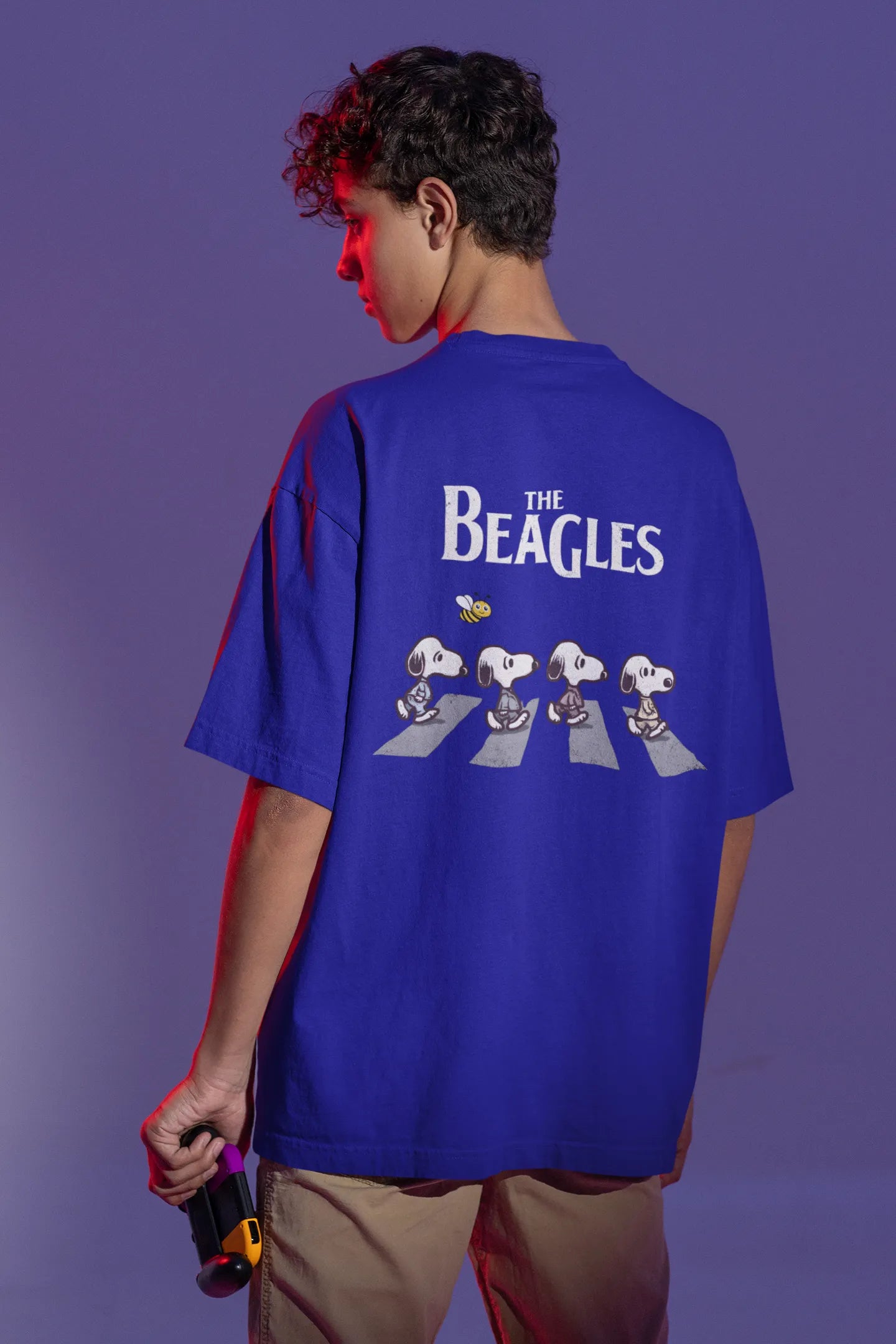 Back view of male Model showcasing blue oversized tee with a The Beagles animated series themed design, featuring the cool canine quartet from ourt disney collection of oversized tees.