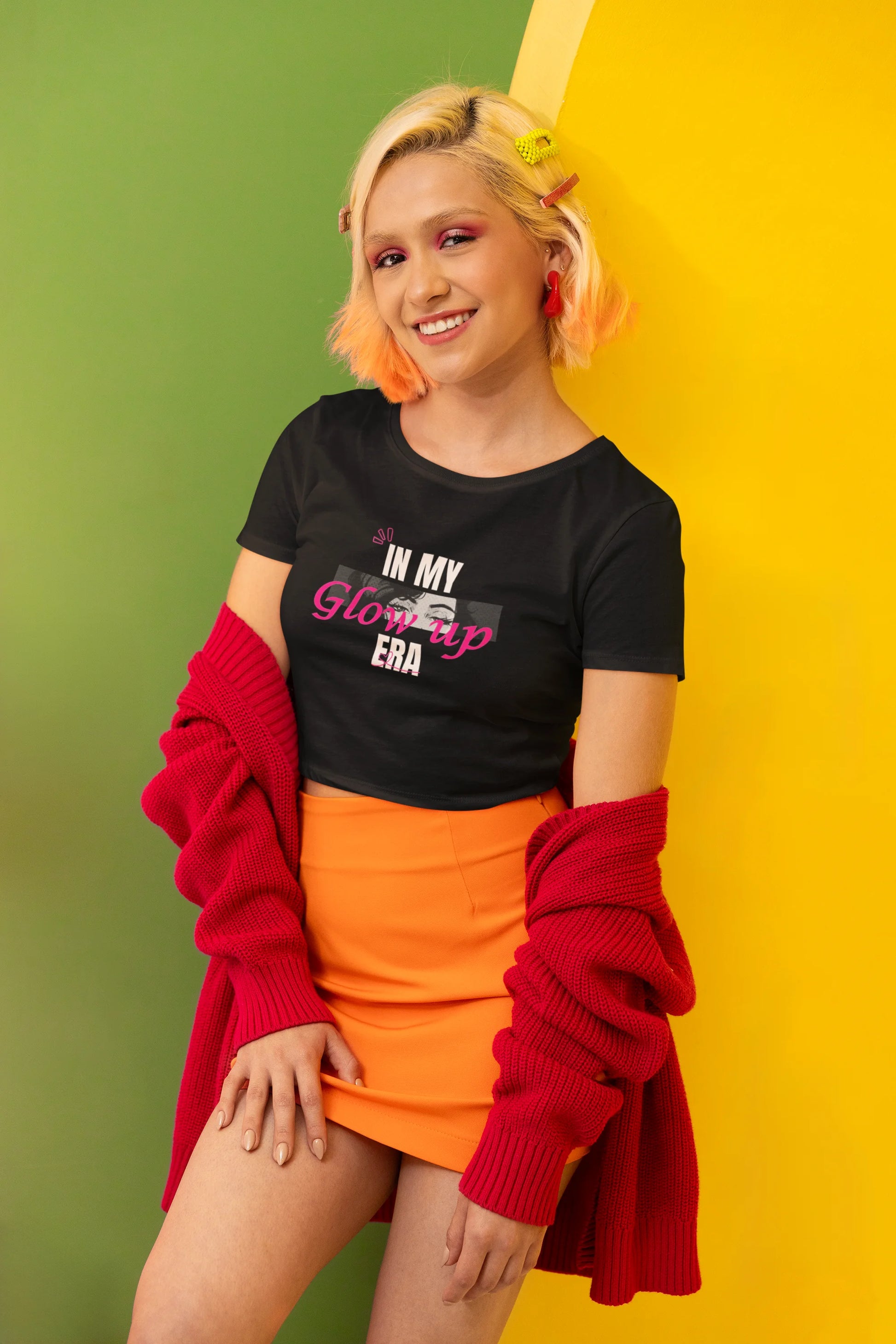 Side view of a female model wearing a black crop top with a floral "in my glow up era" design, exuding confidence and positivity.