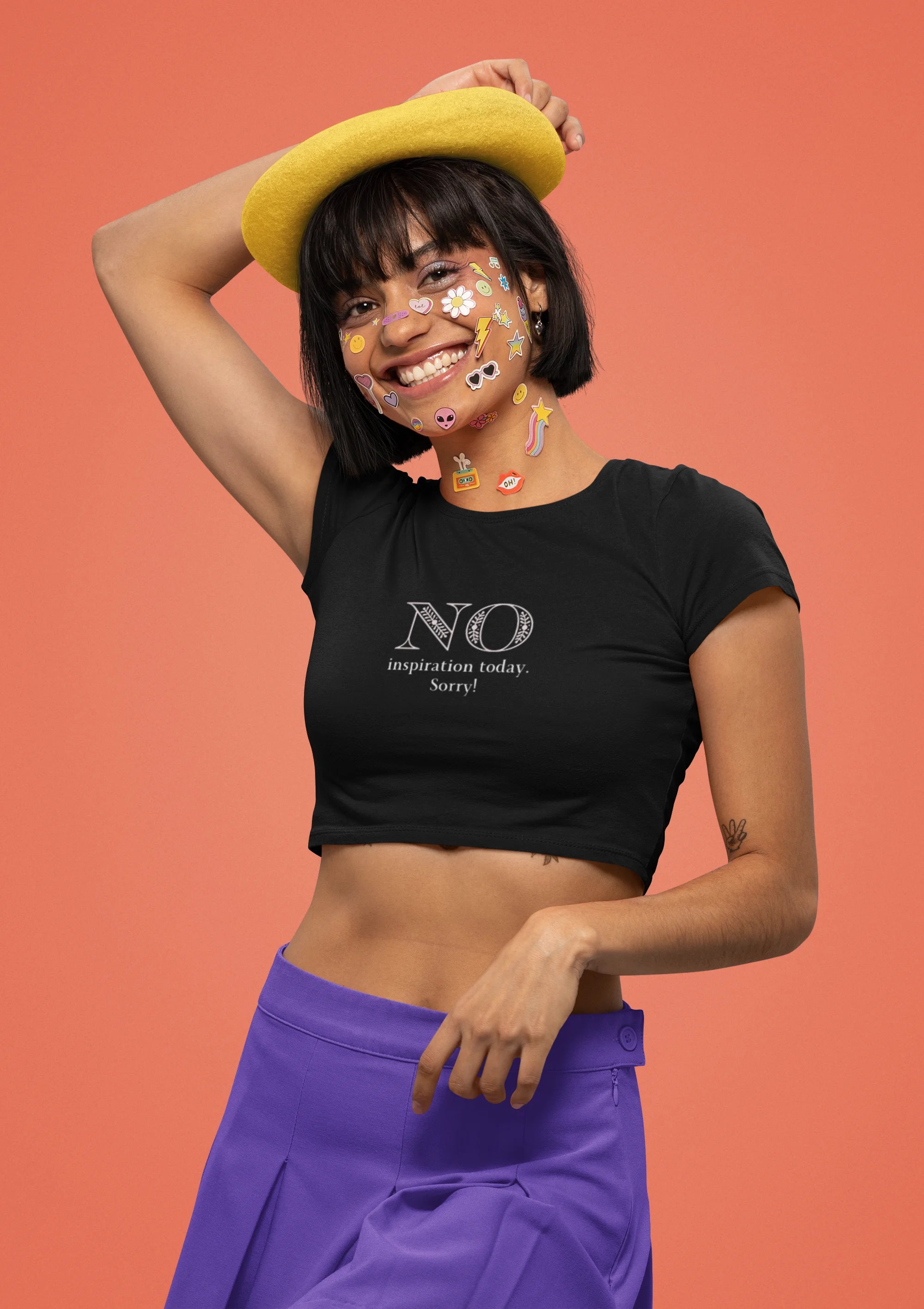 Left side view of female model wearing a black crop top with "No Inspiration Today" text, exuding a cool and relatable vibe.