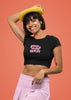 First front view of female model wearing a stylish black crop top with a bold 100% that bitch design, exuding confidence and attitude.