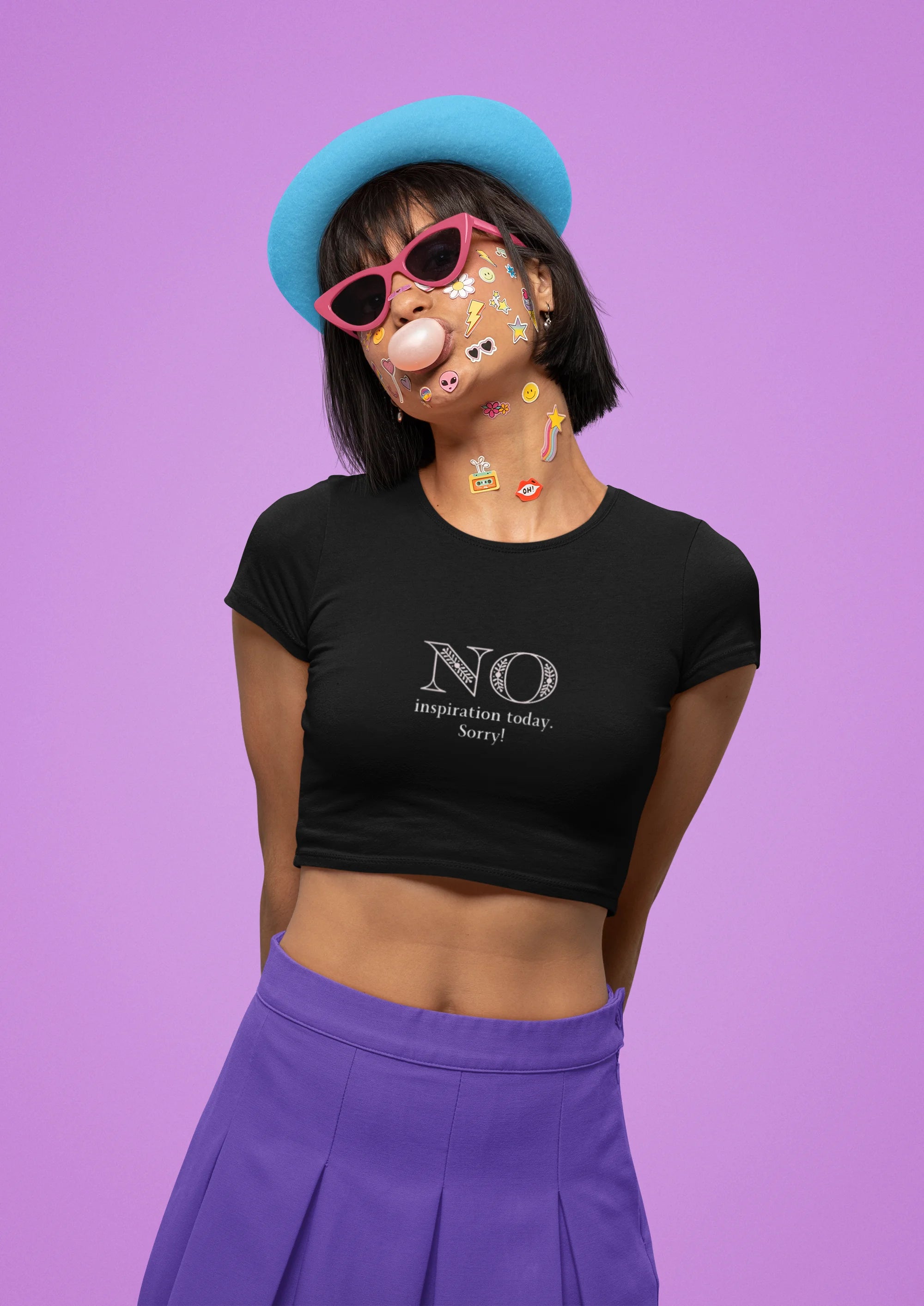 Front view of female model wearing a black crop top with "No Inspiration Today" text, exuding a cool and relatable vibe.