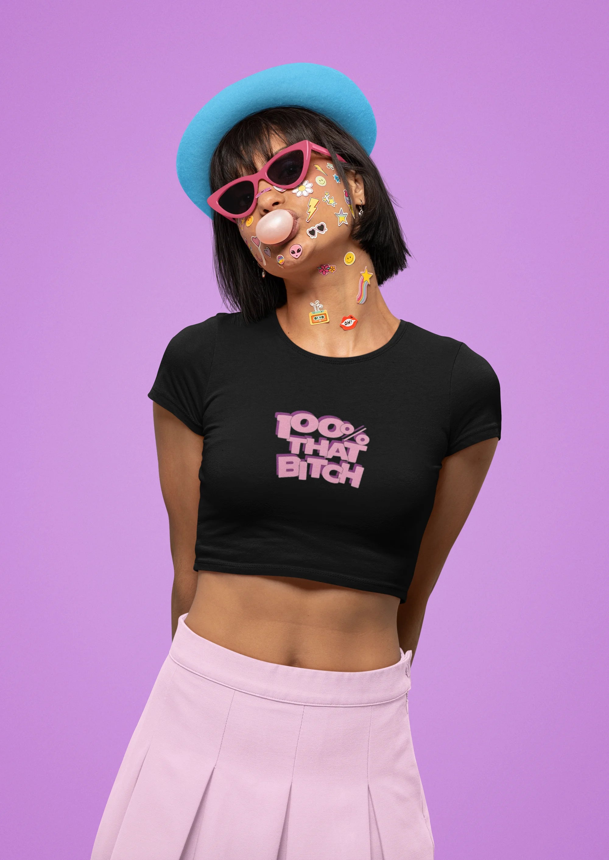 Second front view of female model wearing a stylish black crop top with a bold 100% that bitch design, exuding confidence and attitude.