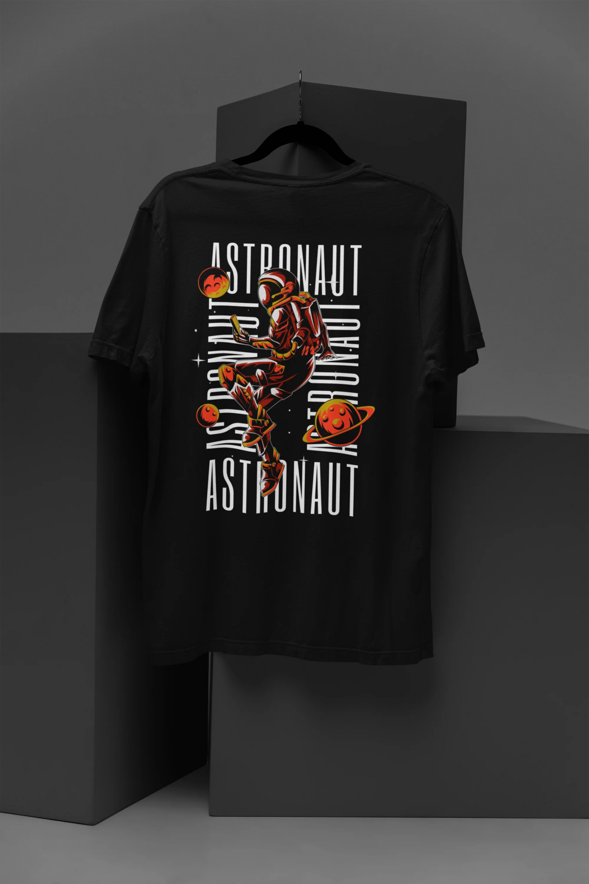 Back design of a black oversized t-shirt featuring a captivating "celestial" design that incorporates subtle elements of the Milky Way galaxy, planets, and the wonders of space. Ideal for aspiring astronauts and space enthusiasts.
