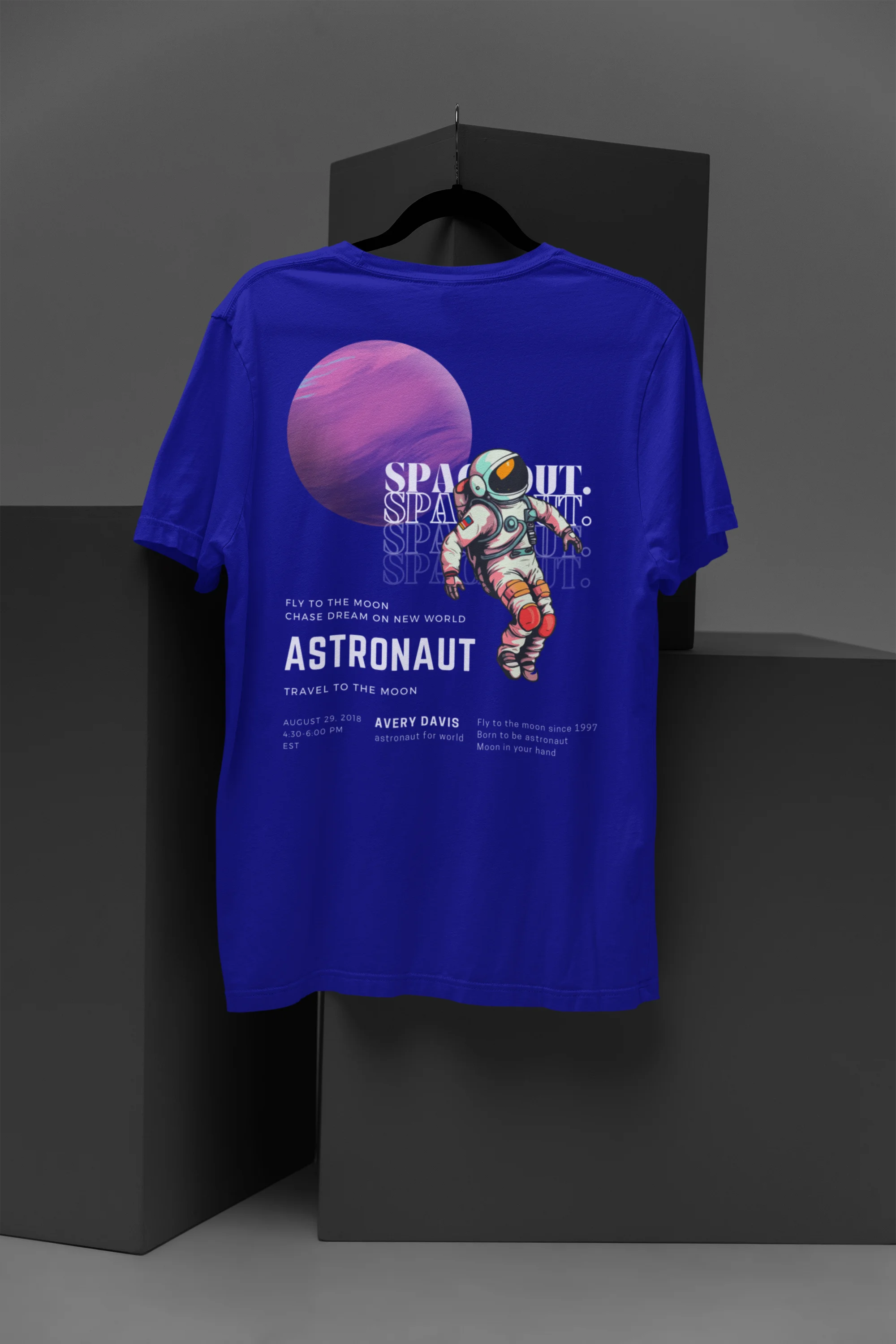 Back view of a blue oversized t-shirt featuring a design inspired by the cosmos and galaxies "Fly Me to the Moon" and subtle hints of space exploration.