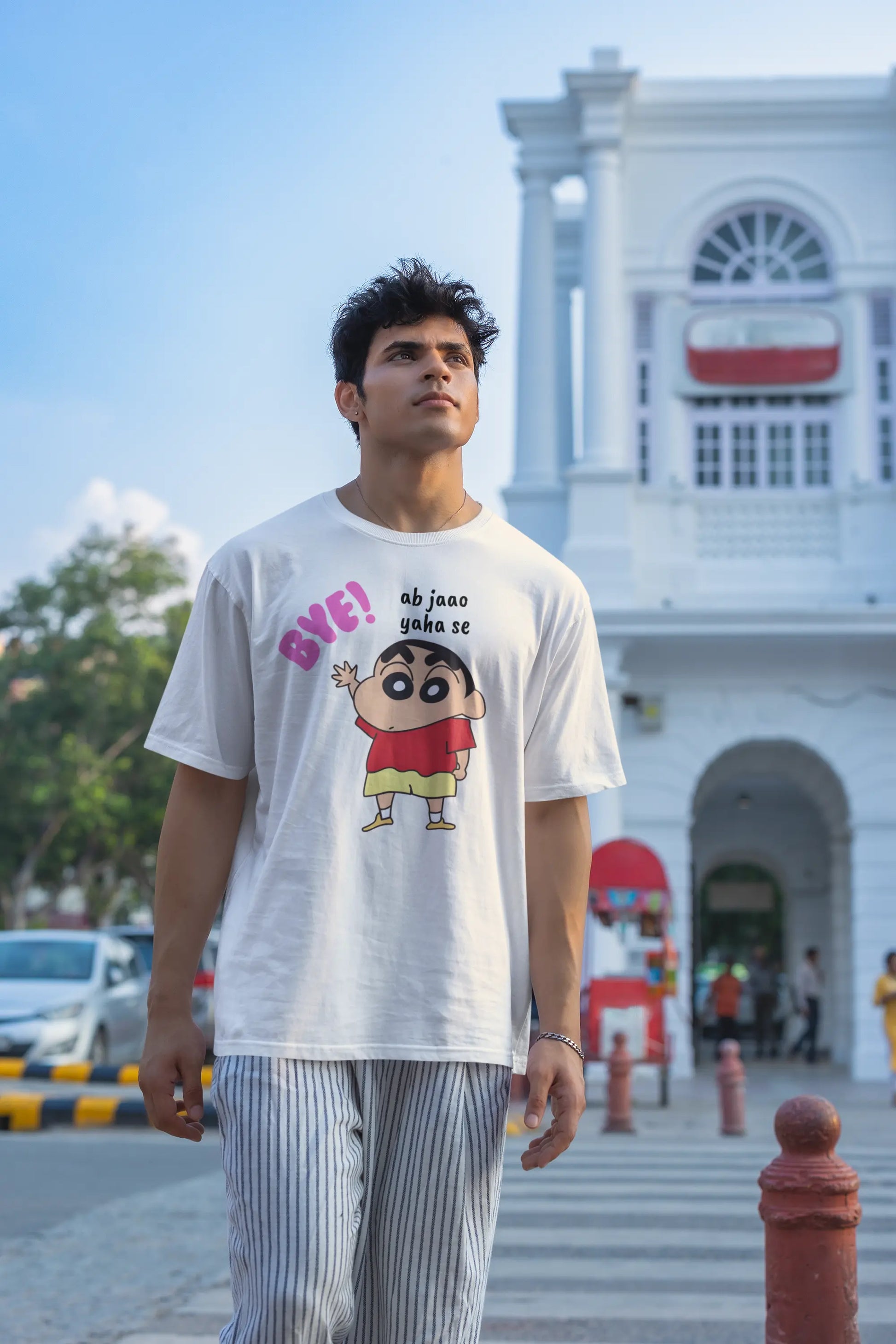 Second front view of an male model wearing an off-white oversized tee featuring Shinchan saying "Ab Jhao" in Hindi. A perfect blend of humor and nostalgia for Shinchan fans.