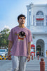 Second front view of male model wearing a dirty purple oversized tee featuring Shinchan with a classic bump on his head. A perfect blend of humor and nostalgia for Shinchan fans.