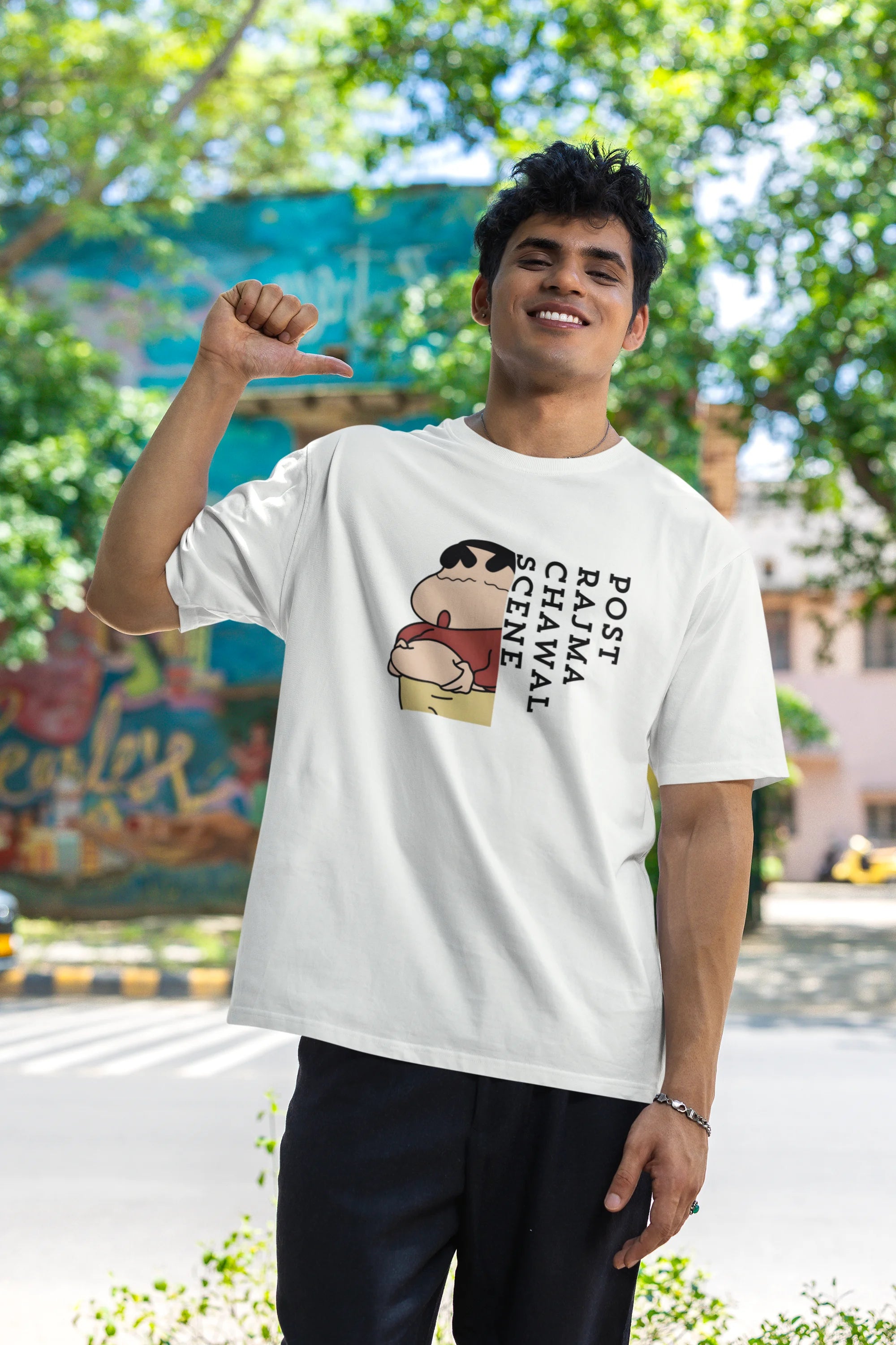 First front image of male model wearing an oversized off-white tee with a humorous design of Shinchan enjoying a food coma. A must-have for Shinchan fans and food lovers.