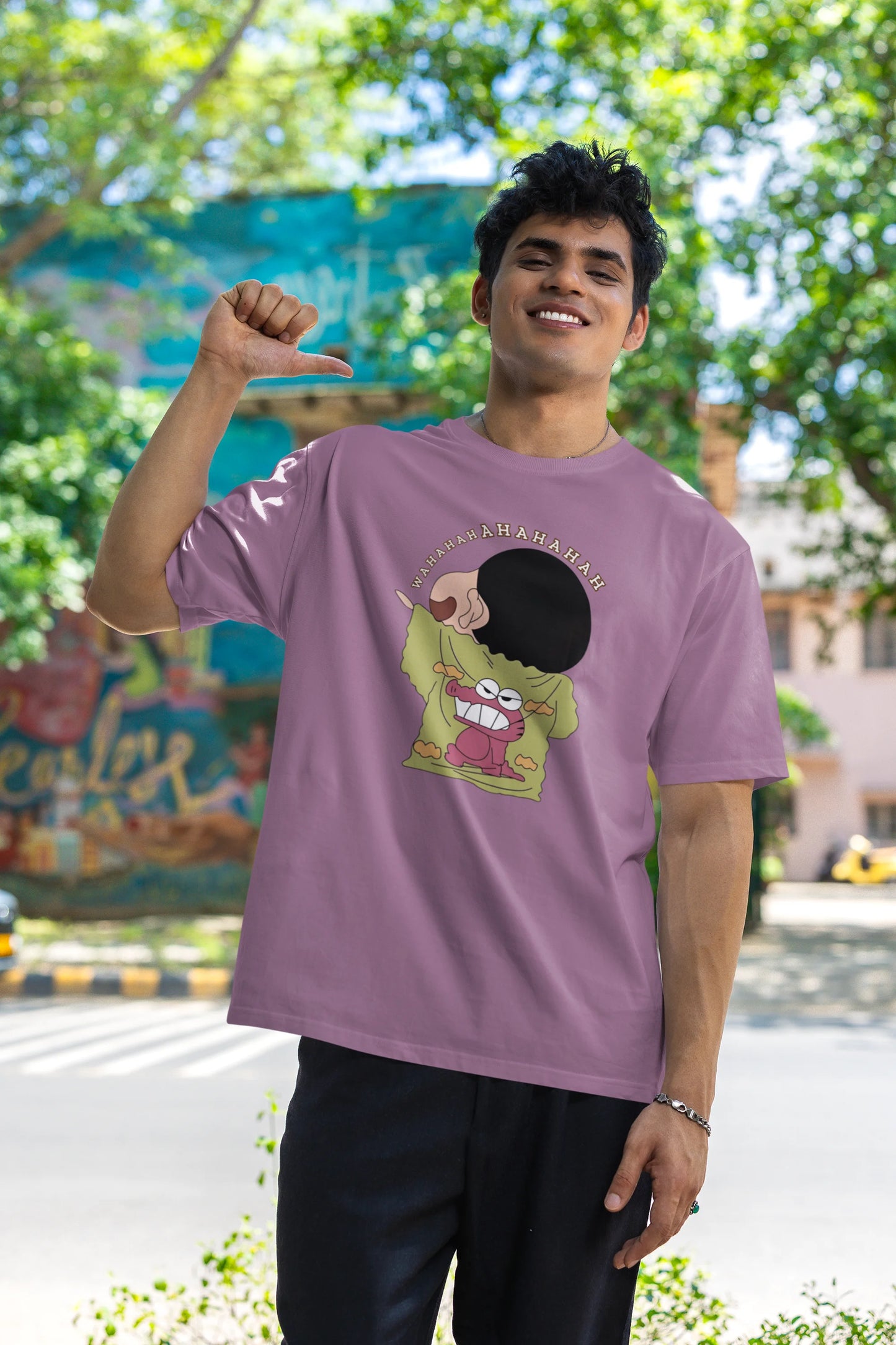 Third front view of male model wearing a dirty purple oversized t-shirt with a design of Shinchan laughing hysterically. Perfect for Shinchan fans who love the character's humor.