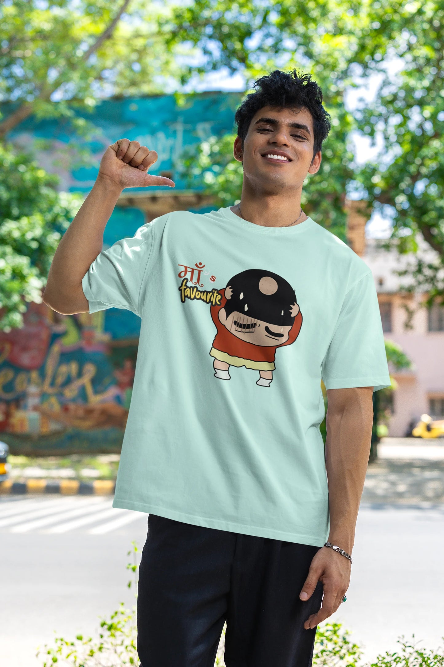 First front view of male model wearing a mint green oversized tee featuring Shinchan with a classic bump on his head. A perfect blend of humor and nostalgia for Shinchan fans.