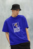 Front view of a male model wearing a royal blue oversized t-shirt featuring a design inspired by Alessia Cara's song 