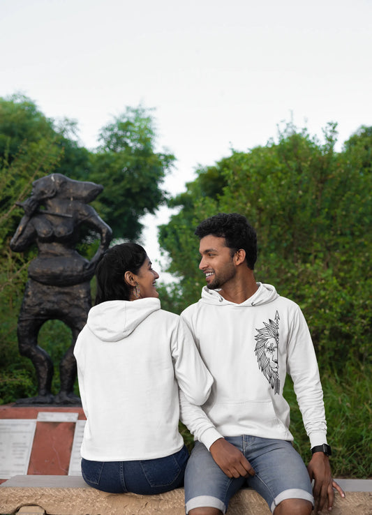 First front and back view of a couple wearing matching hoodies, one with a lion outline and the other with a lioness outline.