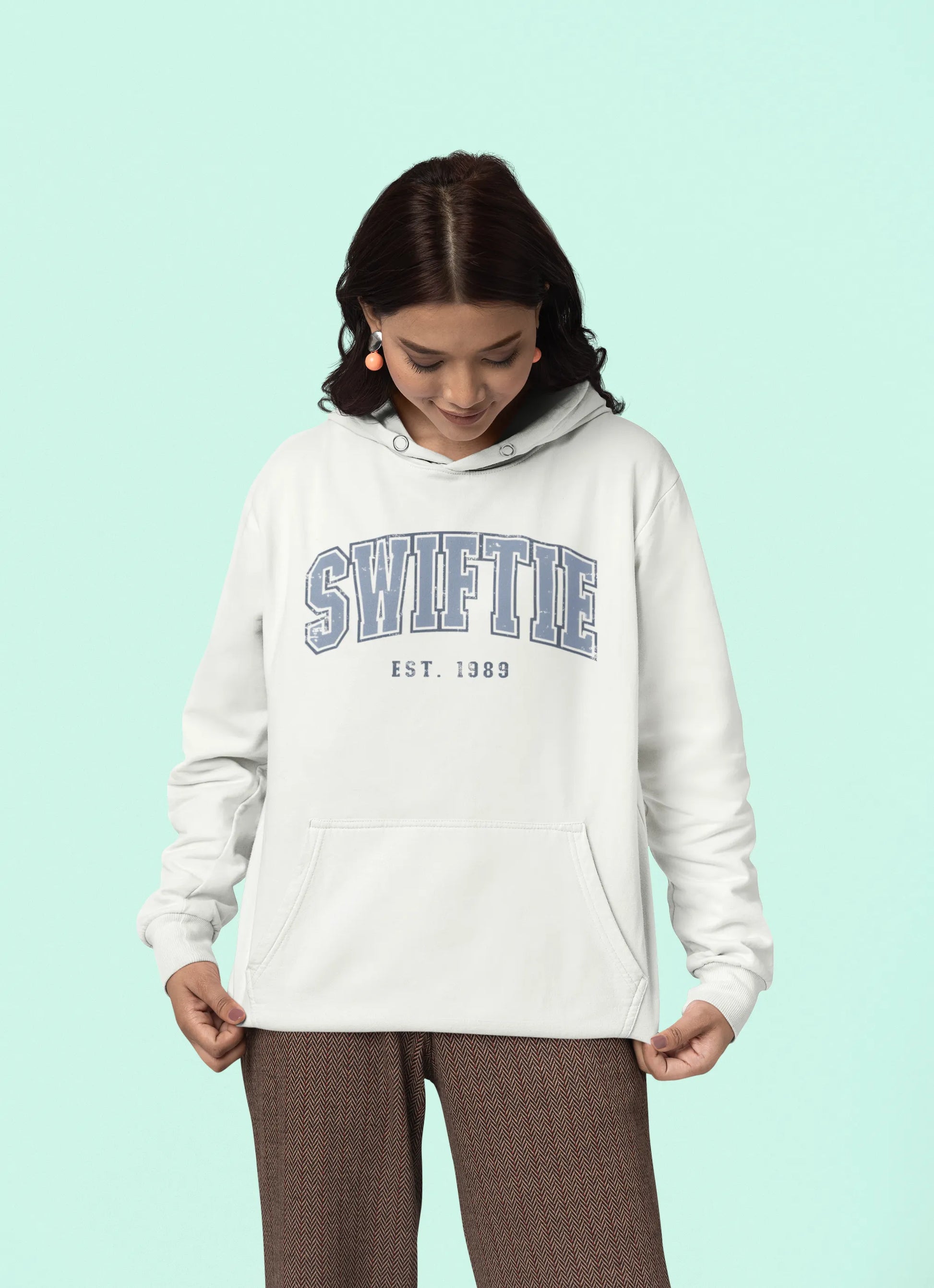 Third front view of a female Model wearing an off-white Swiftie hoodie, perfect for Taylor Swift fans and Eras Tour enthusiasts.