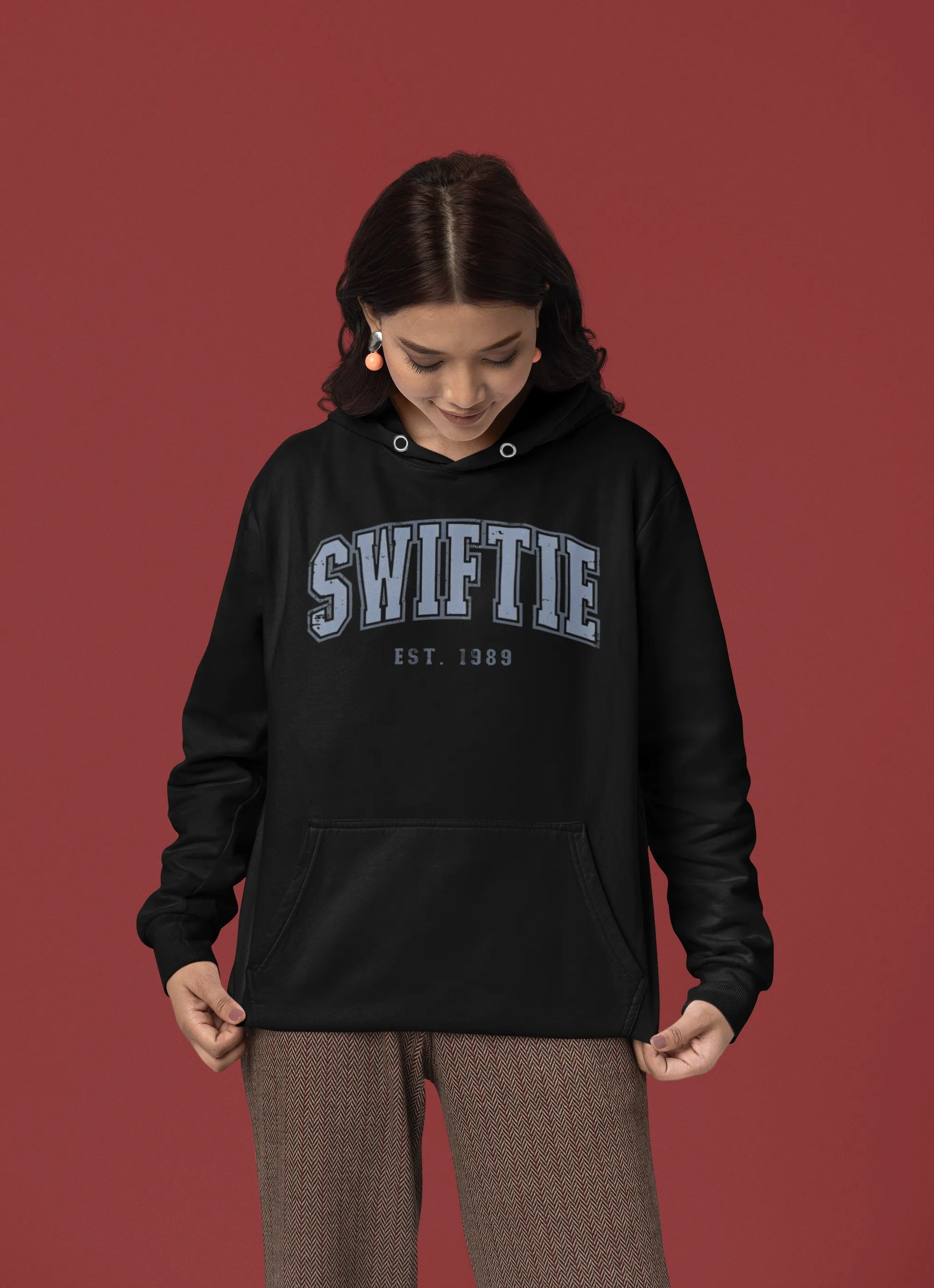 Third front view of a female Model wearing an black Swiftie hoodie, perfect for Taylor Swift fans and Eras Tour enthusiasts.