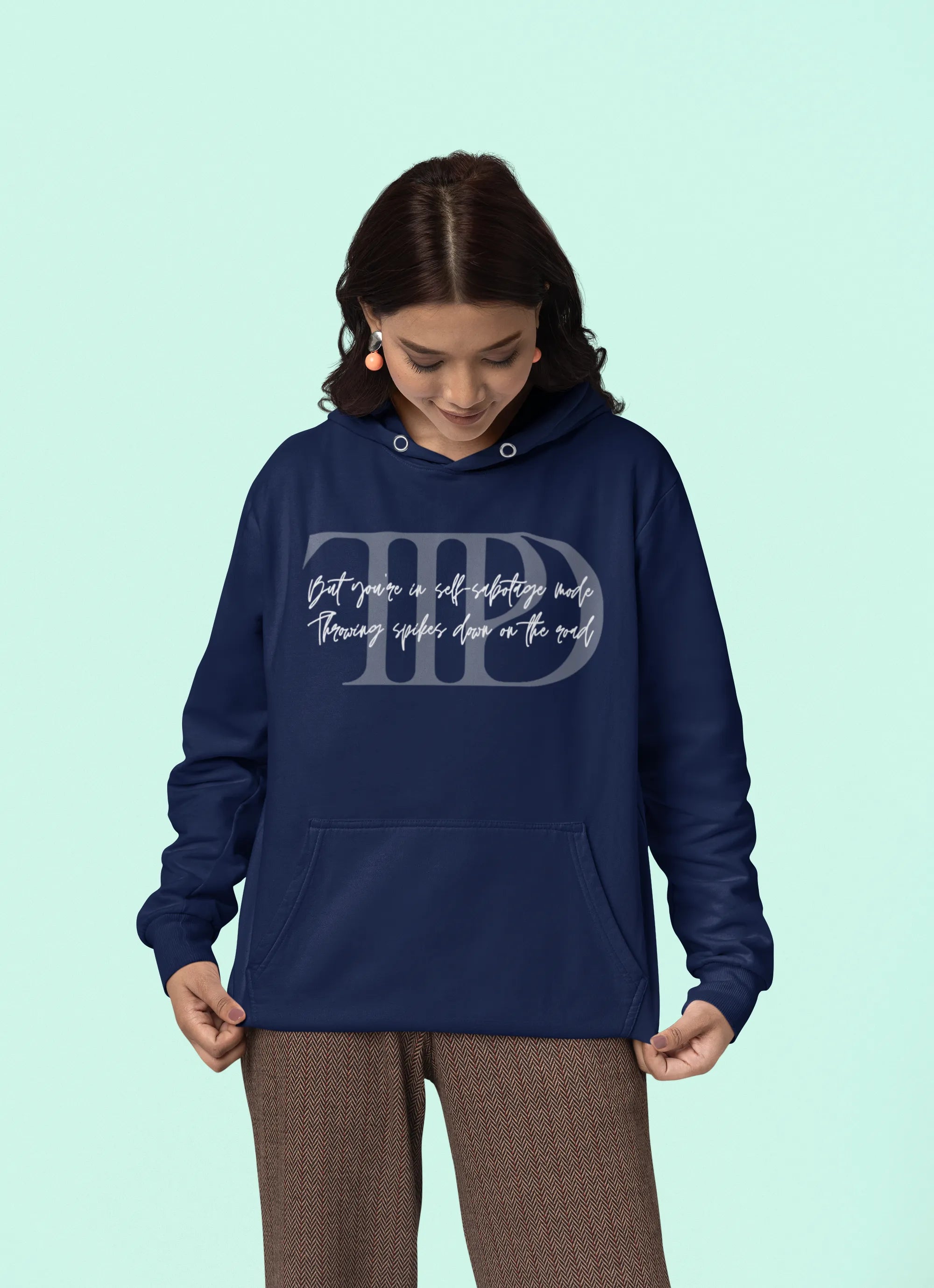 Third front view of a female model wearing a navy blue oversized, cozy hoodie featuring "Lamenting" lyrics from Taylor Swift's TTPD era. Perfect for Swifties looking for comfortable Eras Tour merch.