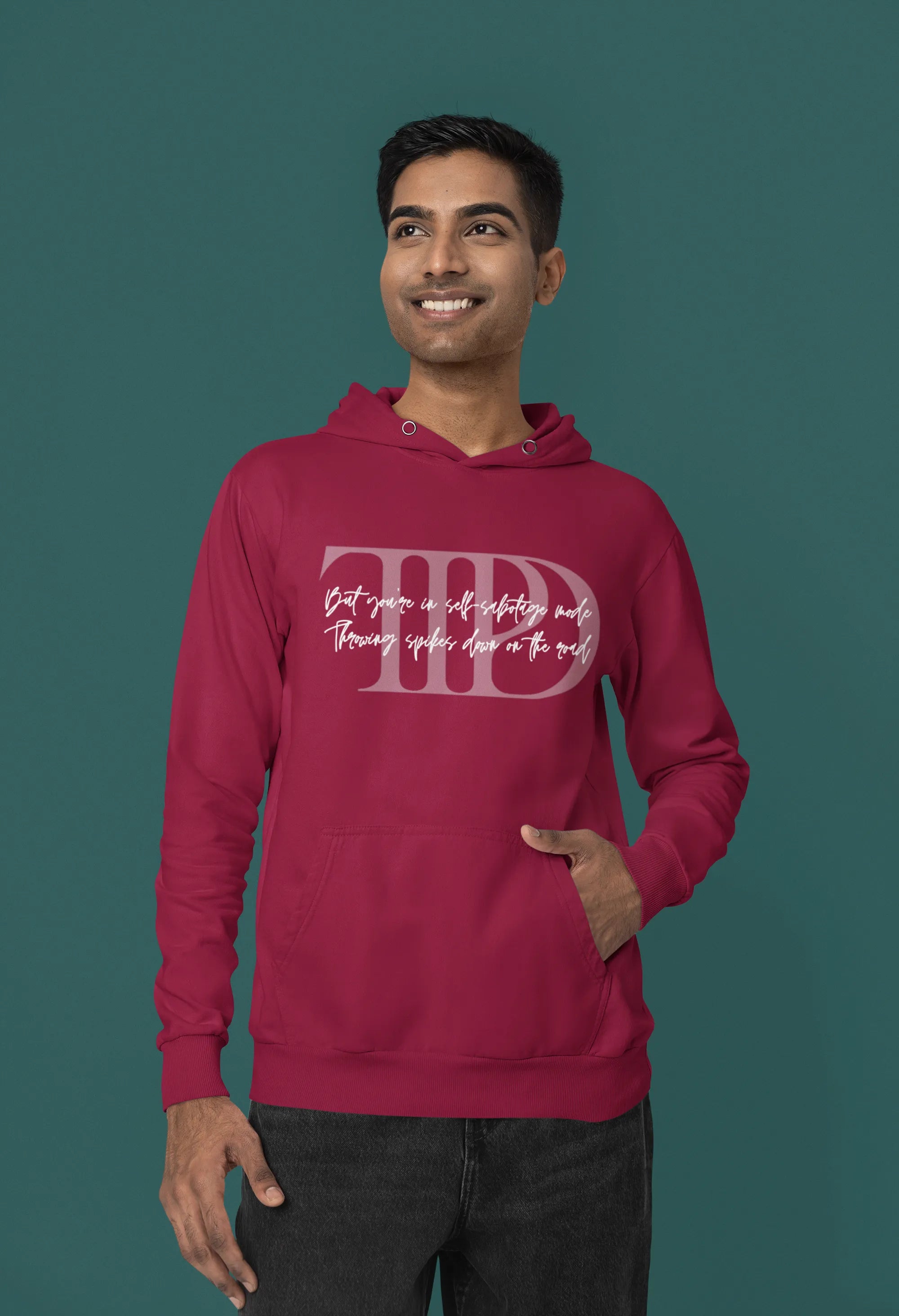 First front view of a male model wearing a maroon oversized, cozy hoodie featuring "Lamenting" lyrics from Taylor Swift's TTPD era. Perfect for Swifties looking for comfortable Eras Tour merch.