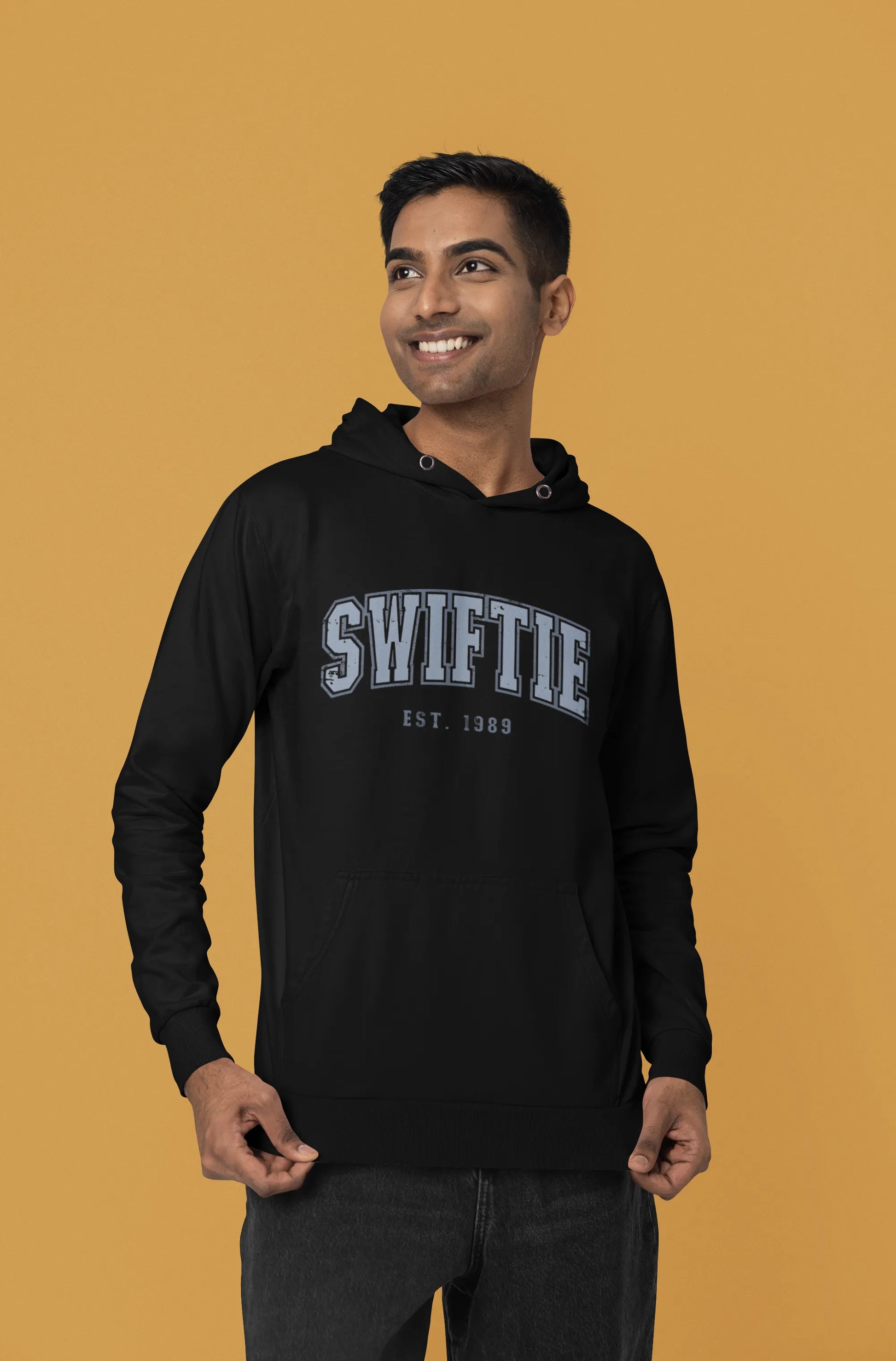Side view of a male Model wearing an black Swiftie hoodie, perfect for Taylor Swift fans and Eras Tour enthusiasts.