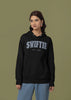 Second front view of a female Model wearing an black Swiftie hoodie, perfect for Taylor Swift fans and Eras Tour enthusiasts.